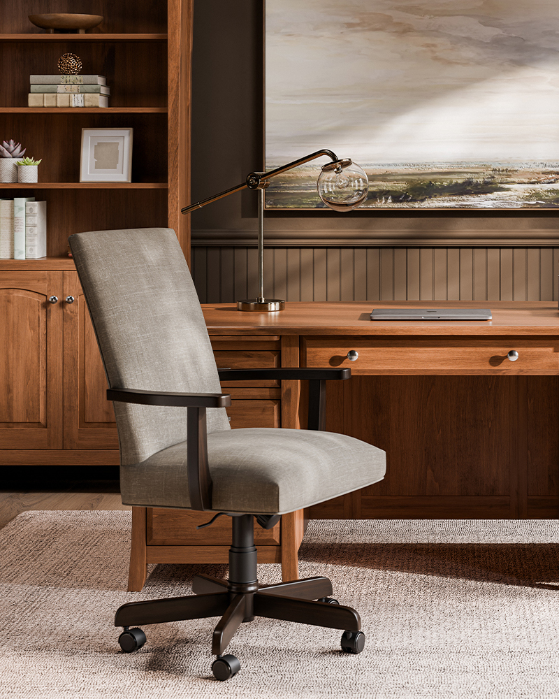 Close-up of woodworking tools with wooden handles, placed on a marked wooden surface, used for crafting solid wood furniture.