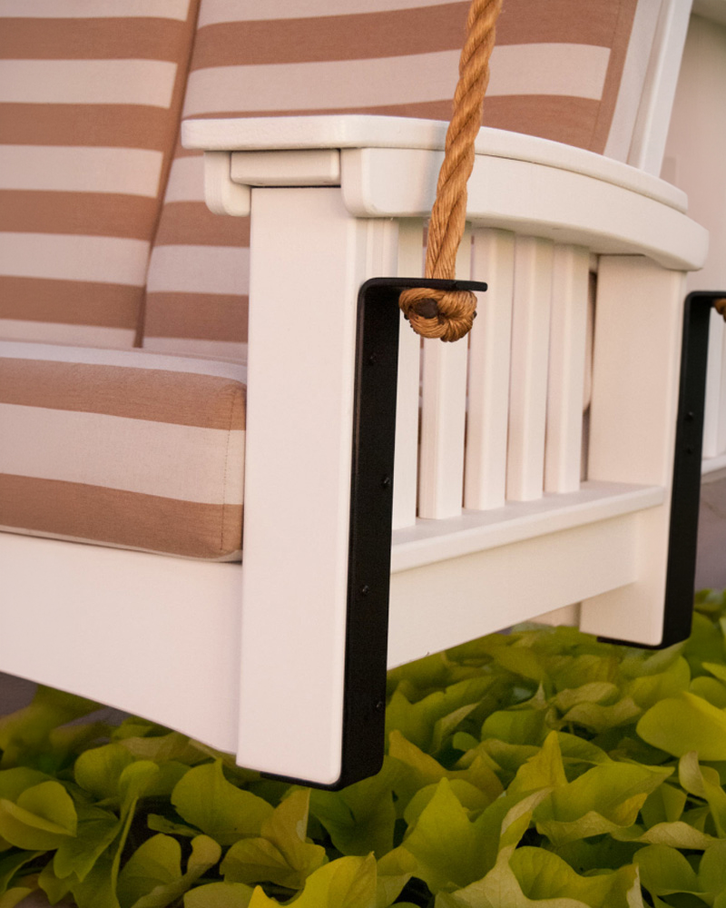 Exterior view of Heirloom Amish Furniture store, showing the storefront with signs and outdoor furniture displayed along the sidewalk.