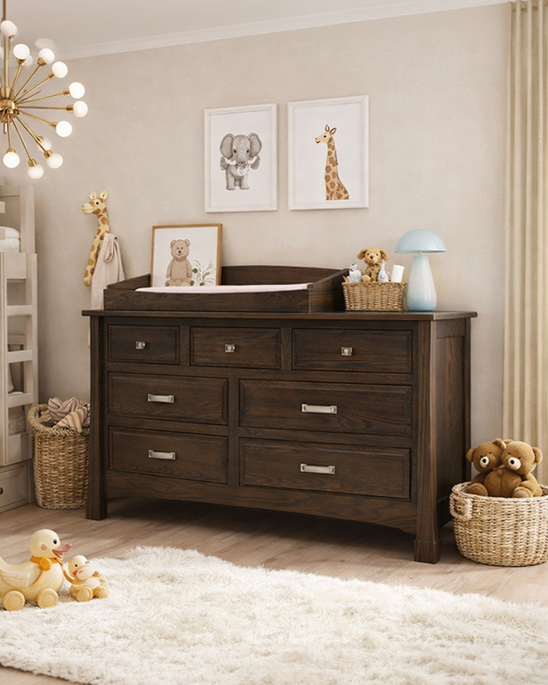Solid wood nursery dresser with changing top in a warm children's room.