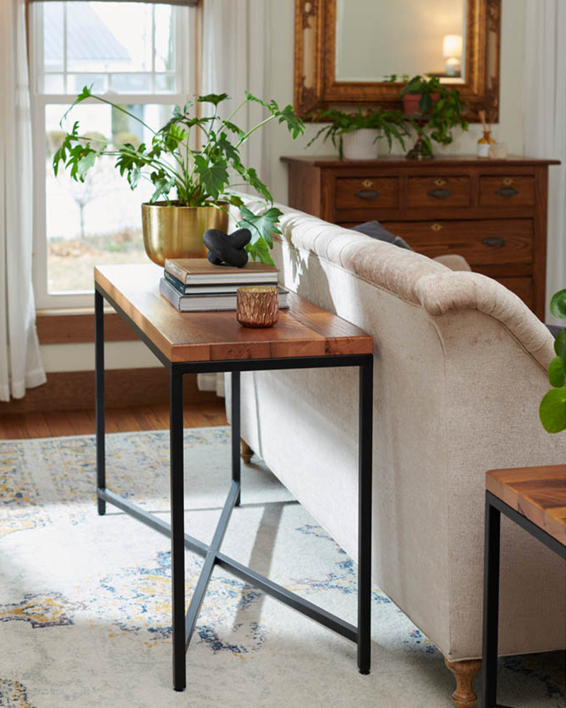 Exterior view of Heirloom Amish Furniture store, showing the storefront with signs and outdoor furniture displayed along the sidewalk.