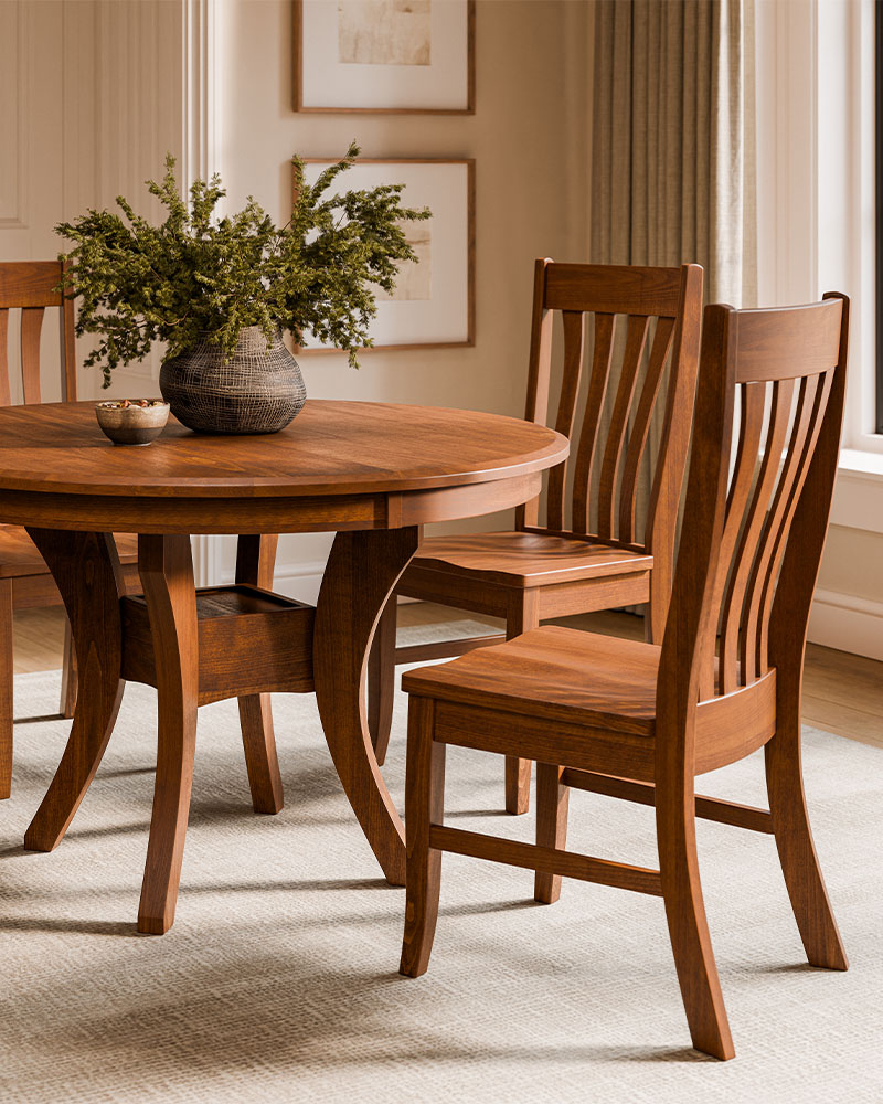 Solid wood dining room furniture with round table and slat-back chairs.