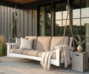 Cushioned porch swing designed for a covered outdoor space.